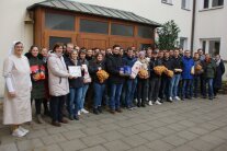 Gruppenfoto im Innenhof der Straubinger Ursulinen. Lehrkräfte und Studierende überreichen Lebensmittel und Geldspenden.